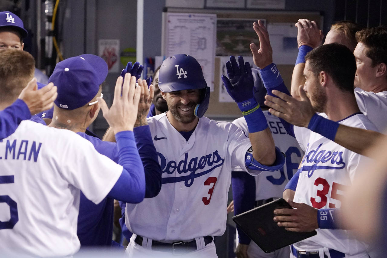 Los Angeles Dodgers' Chris Taylor is congratulated by teammates in the dugout after hitting a solo ...