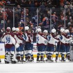
              Colorado Avalanche players celebrate a win over the Edmonton Oilers in an NHL hockey game Saturday, April 9, 2022, in Edmonton, Alberta. (Jason Franson/The Canadian Press via AP)
            