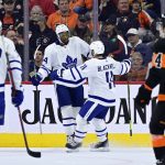 
              Toronto Maple Leafs' Wayne Simmonds, second from left, celebrates his goal with Colin Blackwell (11) during the second period of an NHL hockey game against the Philadelphia Flyers, Saturday, April 2, 2022, in Philadelphia. (AP Photo/Derik Hamilton)
            