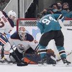 
              Edmonton Oilers goaltender Mike Smith (41) blocks a shot by San Jose Sharks left wing Alexander Barabanov (94) as Tyson Barrie (22) defends during the second period of an NHL hockey game Tuesday, April 5, 2022, in San Jose, Calif. (AP Photo/Tony Avelar)
            