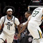 
              Utah Jazz guard Mike Conley, left, dribbles around a pick set by center Rudy Gobert, right, as Portland Trail Blazers guard Keon Johnson, center defends during the second half of an NBA basketball game in Portland, Ore., Sunday, April 10, 2022. The Jazz won 111-80. (AP Photo/Steve Dykes)
            