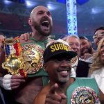
              Britain’s Tyson Fury celebrates with his wife Paris, right, and trainer SugarHill Steward after beating Britain’s Dillian Whyte to win their WBC heavyweight title boxing fight at Wembley Stadium in London, Saturday, April 23, 2022. (Nick Potts/PA via AP)
            