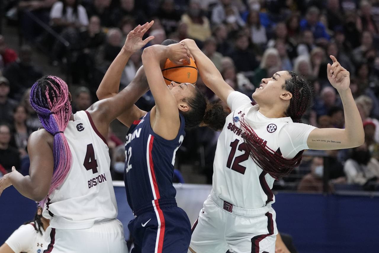 South Carolina's Aliyah Boston and Brea Beal stop UConn's Evina Westbrook during the second half of...