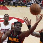 
              Atlanta Hawks Clint Capela, front left, and John Collins, right, reach for a rebound in front of Miami Heat center Bam Adebayo, back left, in the first half of an NBA playoff basketball game Sunday, April 24, 2022, in Atlanta. (AP Photo/John Bazemore)
            