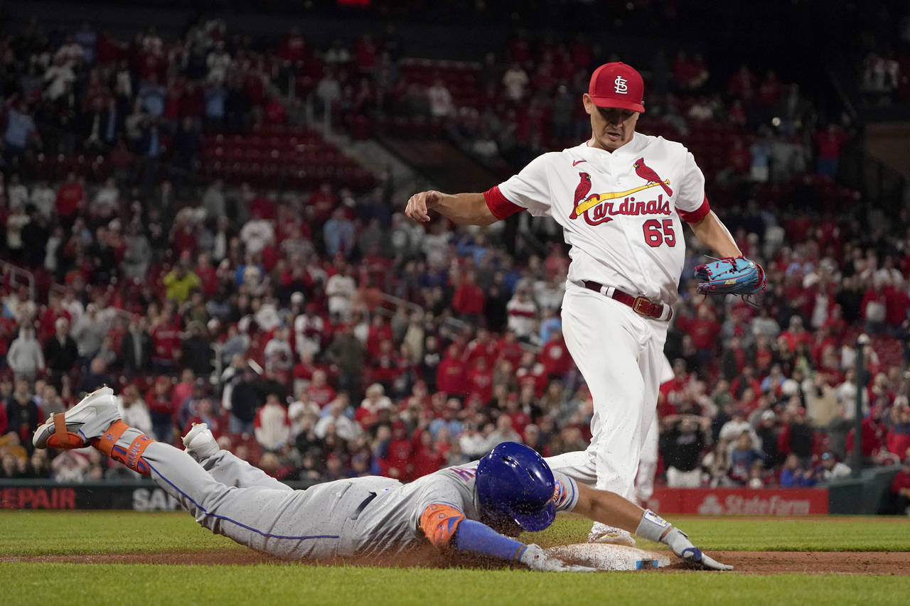 New York Mets' Dominic Smith is safe at first for a single as St. Louis Cardinals relief pitcher Gi...