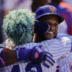 
              New York Mets' Robinson Cano, right, hugs Francisco Lindor, left, after hitting a solo home run off Arizona Diamondbacks starting pitcher Zach Davies in the fourth inning of a baseball game, Friday, April 15, 2022, in New York. (AP Photo/John Minchillo)
            