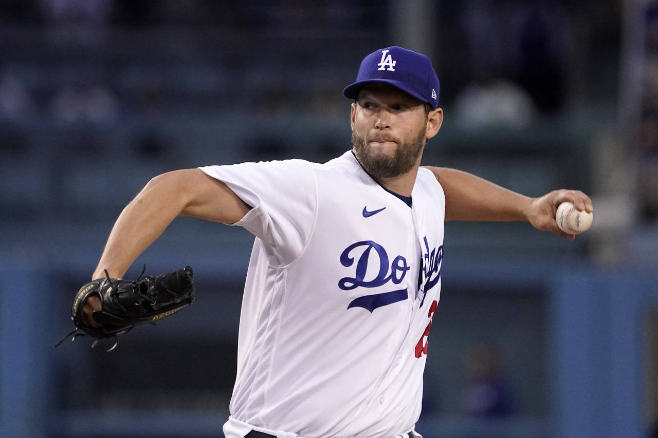 Los Angeles Dodgers starting pitcher Clayton Kershaw throws to the plate during the first inning of...