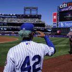 
              New York Mets shortstop Francisco Lindor wears the number 42 in honor of Jackie Robinson as he walks on the field before a baseball game against the Arizona Diamondbacks, Friday, April 15, 2022, in New York. (AP Photo/John Minchillo)
            