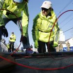 
              Volunteers set up the timing mats at the starting line before the start of the 126th Boston Marathon, Monday, April 18, 2022, in Hopkinton, Mass. (AP Photo/Mary Schwalm)
            