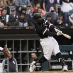 
              Chicago White Sox's Josh Harrison hits a double against the Los Angeles Angels during the fifth inning of a baseball game in Chicago, Saturday, April 30, 2022. (AP Photo/Nam Y. Huh)
            