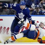 
              Toronto Maple Leafs left wing Michael Bunting (58) picks up the penalty for the hit on New York Islanders defenseman Noah Dobson (8) during the first period of an NHL hockey game, in Toronto, Sunday, April 17, 2022. (Frank Gunn/The Canadian Press via AP)
            