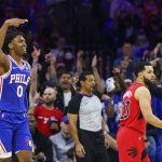 
              Philadelphia 76ers' Tyrese Maxey, left, reacts to his three-pointer as Toronto Raptors' Fred VanVleet, right, looks on during the first half of Game 1 of an NBA basketball first-round playoff series, Saturday, April 16, 2022, in Philadelphia. (AP Photo/Chris Szagola)
            