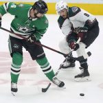 
              Arizona Coyotes center Nick Schmaltz (8) and Dallas Stars left wing Jamie Benn (14) vie for control of the puck during the first period of an NHL hockey game in Dallas, Wednesday, April 27, 2022. (AP Photo/LM Otero)
            