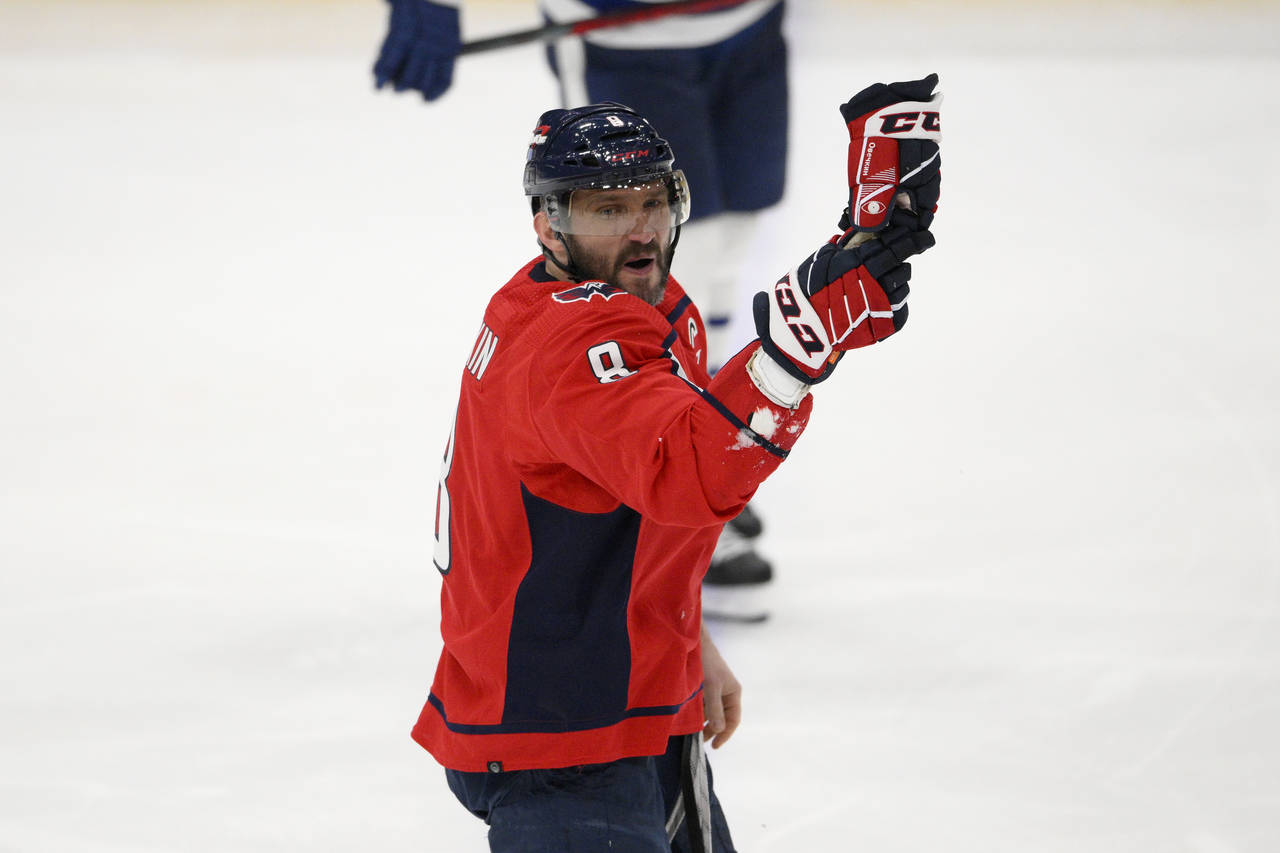 Washington Capitals left wing Alex Ovechkin (8) skates to the bench and gestures after he was injur...