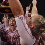 
              Oklahoma team celebrates their victory together after the NCAA college women's gymnastics championships, Saturday, April 16, 2022, in Fort Worth, Texas. (AP Photo/Gareth Patterson)
            