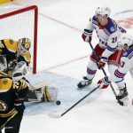 
              Boston Bruins' Linus Ullmark (35) blocks a shot by New York Rangers' Alexis Lafrenière (13) during the third period of an NHL hockey game, Saturday, April 23, 2022, in Boston. (AP Photo/Michael Dwyer)
            