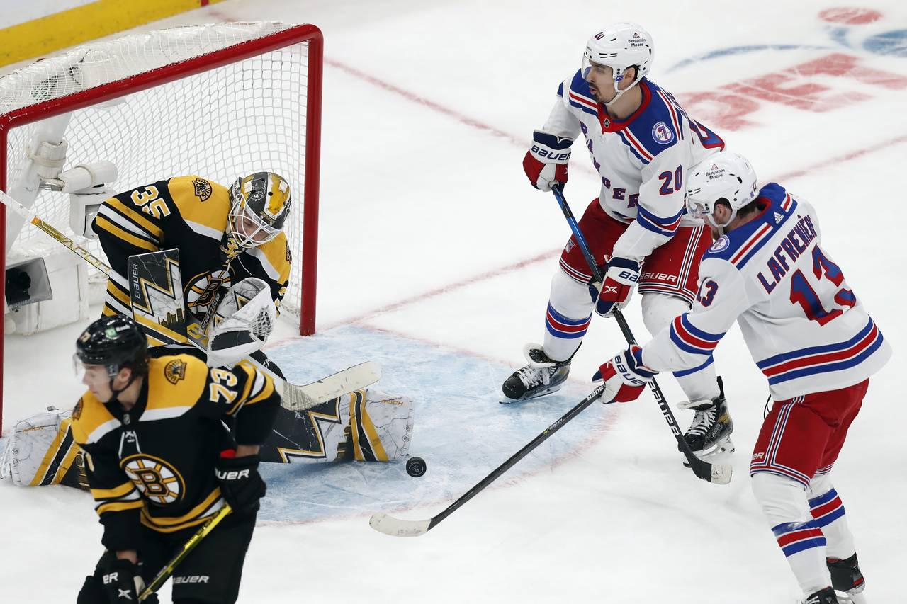 Boston Bruins' Linus Ullmark (35) blocks a shot by New York Rangers' Alexis Lafrenière (13) during...