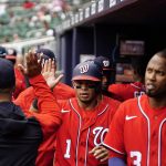 
              Washington Nationals' Cesar Hernandez (1) high-fives teammate after scoring in the first inning of a baseball game against the Atlanta Braves, Wednesday, April 13, 2022, in Atlanta. (AP Photo/Brynn Anderson)
            