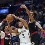 
              New Orleans Pelicans guard CJ McCollum (3) goes to the basket between Portland Trail Blazers guard Keon Johnson (6) and forward Greg Brown III in the second half of an NBA basketball game in New Orleans, Thursday, April 7, 2022. (AP Photo/Gerald Herbert)
            