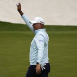 
              Stewart Cink holds up his ball after a hole-in-one on the 16th hole during the second round at the Masters golf tournament on Friday, April 8, 2022, in Augusta, Ga. (AP Photo/Charlie Riedel)
            