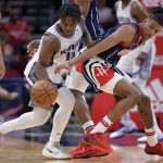 
              Sacramento Kings guard Davion Mitchell, left, attempts to steal the ball from Houston Rockets guard Jalen Green, right, during the first half of an NBA basketball game Friday, April 1, 2022, in Houston. (AP Photo/Michael Wyke)
            