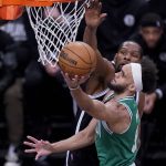 
              Boston Celtics guard Derrick White (9) shoots against Brooklyn Nets forward Kevin Durant, behind, during the first half of Game 3 of an NBA basketball first-round playoff series, Saturday, April 23, 2022, in New York. (AP Photo/John Minchillo)
            