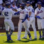 
              New York Mets' Starling Marte, center left, celebrates with Francisco Lindor, left, after hitting a three-run home run off Arizona Diamondbacks relief pitcher Caleb Smith in the eighth inning of a baseball game, Friday, April 15, 2022, in New York. (AP Photo/John Minchillo)
            