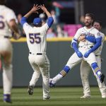 
              Seattle Mariners' Jesse Winker, front right, is lifted by Ty France as he celebrates a win over Kansas City Royals in 12 innings of a baseball game, Sunday, April 24, 2022, in Seattle. (AP Photo/John Froschauer)
            