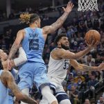 
              Minnesota Timberwolves center Karl-Anthony Towns, right, shoots next to Memphis Grizzlies forward Brandon Clarke (15) during the second half in Game 4 of an NBA basketball first-round playoff series Saturday, April 23, 2022, in Minneapolis. The Timberwolves won 119-118. (AP Photo/Craig Lassig)
            