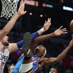 
              Oklahoma City Thunder guard Melvin Frazier Jr., right, shoots as Los Angeles Clippers center Ivica Zubac defends during the second half of an NBA basketball game Sunday, April 10, 2022, in Los Angeles. (AP Photo/Mark J. Terrill)
            