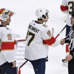 
              Linesman Vaughan Rody (73) shakes hands with Florida Panthers left wing Mason Marchment (17) as goaltender Spencer Knight (30) waits after the team's win against the Nashville Predators in an NHL hockey game Saturday, April 9, 2022, in Nashville, Tenn. Rody is retiring after the season. (AP Photo/Mark Zaleski)
            