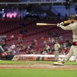 
              San Diego Padres' Eric Hosmer hits an RBI single during the fifth inning of a baseball game against the Cincinnati Reds in Cincinnati, Wednesday, April 27, 2022. (AP Photo/Aaron Doster)
            