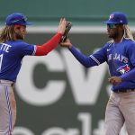 
              Toronto Blue Jays' Bo Bichette, left, celebrates with teammate Raimel Tapia, right, after defeating the Boston Red Sox in a baseball game, Thursday, April 21, 2022, in Boston. (AP Photo/Steven Senne)
            
