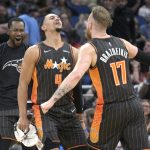 
              Orlando Magic forward Ignas Brazdeikis (17) celebrates with guard Jalen Suggs (4) and guard Terrence Ross, left, after Brazdeikis scored late in the second half of an NBA basketball game against the Cleveland Cavaliers, Tuesday, April 5, 2022, in Orlando, Fla. (AP Photo/Phelan M. Ebenhack)
            