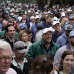 
              Spectators leave the Augusta National Golf Course after play was suspended because of approaching inclement during a practice round for the Masters golf tournament on Tuesday, April 5, 2022, in Augusta, Ga.(AP Photo/Charlie Riedel)
            