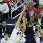 
              Kansas' Mitch Lightfoot (44) battles Villanova's Eric Dixon for the rebound during the first half of a college basketball game in the semifinal round of the Men's Final Four NCAA tournament, Saturday, April 2, 2022, in New Orleans. (AP Photo/Gerald Herbert)
            