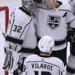 
              Los Angeles Kings goaltender Jonathan Quick (32) celebrates with right wing Dustin Brown (23) after the Kings defeated the Chicago Blackhawks 5-2 in an NHL hockey game Tuesday, April 12, 2022, in Chicago. (AP Photo/Paul Beaty)
            