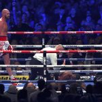 
              Britain's Tyson Fury, left, knocks down Britain's Dillian Whyte to win their WBC heavyweight title boxing fight at Wembley Stadium in London, Saturday, April 23, 2022. (AP Photo/Ian Walton)
            