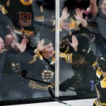 
              Boston Bruins center Marc McLaughlin (26) celebrates with fans after his goal during the first period of an NHL hockey game against the St. Louis Blues, Tuesday, April 12, 2022, in Boston. (AP Photo/Charles Krupa)
            