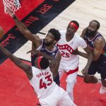 
              Toronto Raptors forward Pascal Siakam (43) is fouled by Philadelphia 76ers' Joel Embiid (21) as Raptors' Chris Boucher (25) and 76ers' James Harden look on during the first half of Game 4 of an NBA basketball first-round playoff series, Saturday, April 23, 2022 in Toronto. (Chris Young/The Canadian Press via AP)
            