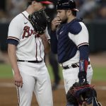 
              Atlanta Braves pitcher Kyle Wright, left, meets with catcher Travis d'Arnaud during the sixth inning of the team's baseball game against the Miami Marlins on Friday, April 22, 2022, in Atlanta. (AP Photo/Ben Margot)
            
