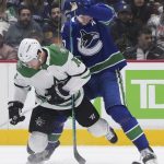 
              Vancouver Canucks' Tyler Myers, right, checks Dallas Stars' Joe Pavelski during the first period of an NHL hockey game in Vancouver, British Columbia, Monday, April 18, 2022. (Darryl Dyck/The Canadian Press via AP)
            