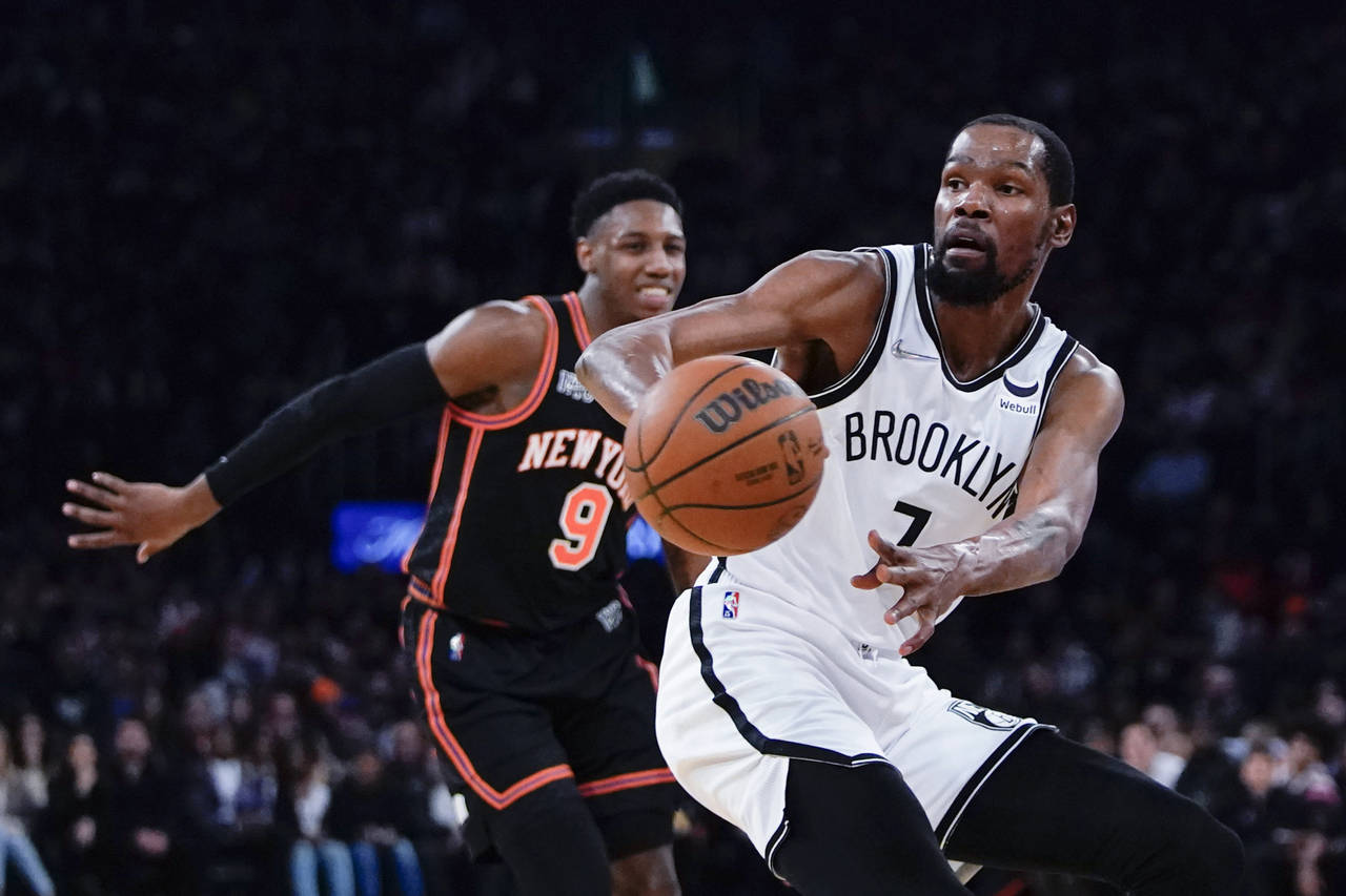 Brooklyn Nets' Kevin Durant (7) passes the ball away from New York Knicks' RJ Barrett (9) during th...