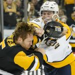 
              Pittsburgh Penguins' Mike Matheson (5) takes a punch from Nashville Predators' Tanner Jeannot (84) as they fight during the second period of an NHL hockey game, Sunday, April 10, 2022, in Pittsburgh. Both players were penalized for fighting. (AP Photo/Keith Srakocic)
            