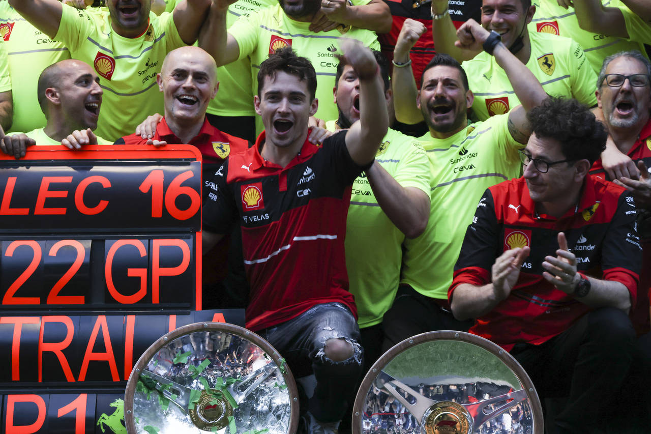Ferrari driver Charles Leclerc, centre, of Monaco celebrates with his team after winning the Austra...