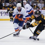 
              Pittsburgh Penguins' Jake Guentzel (59) tries to get the puck past New York Islanders' Andy Greene (4) during the second period of an NHL hockey game Thursday, April 14, 2022, in Pittsburgh. (AP Photo/Keith Srakocic)
            