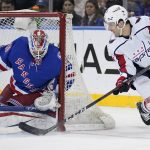 
              New York Rangers goaltender Alexandar Georgiev (40) makes a save against Washington Capitals right wing Garnet Hathaway (21) during the second period of an NHL hockey game, Friday, April 29, 2022, in New York. (AP Photo/John Minchillo)
            