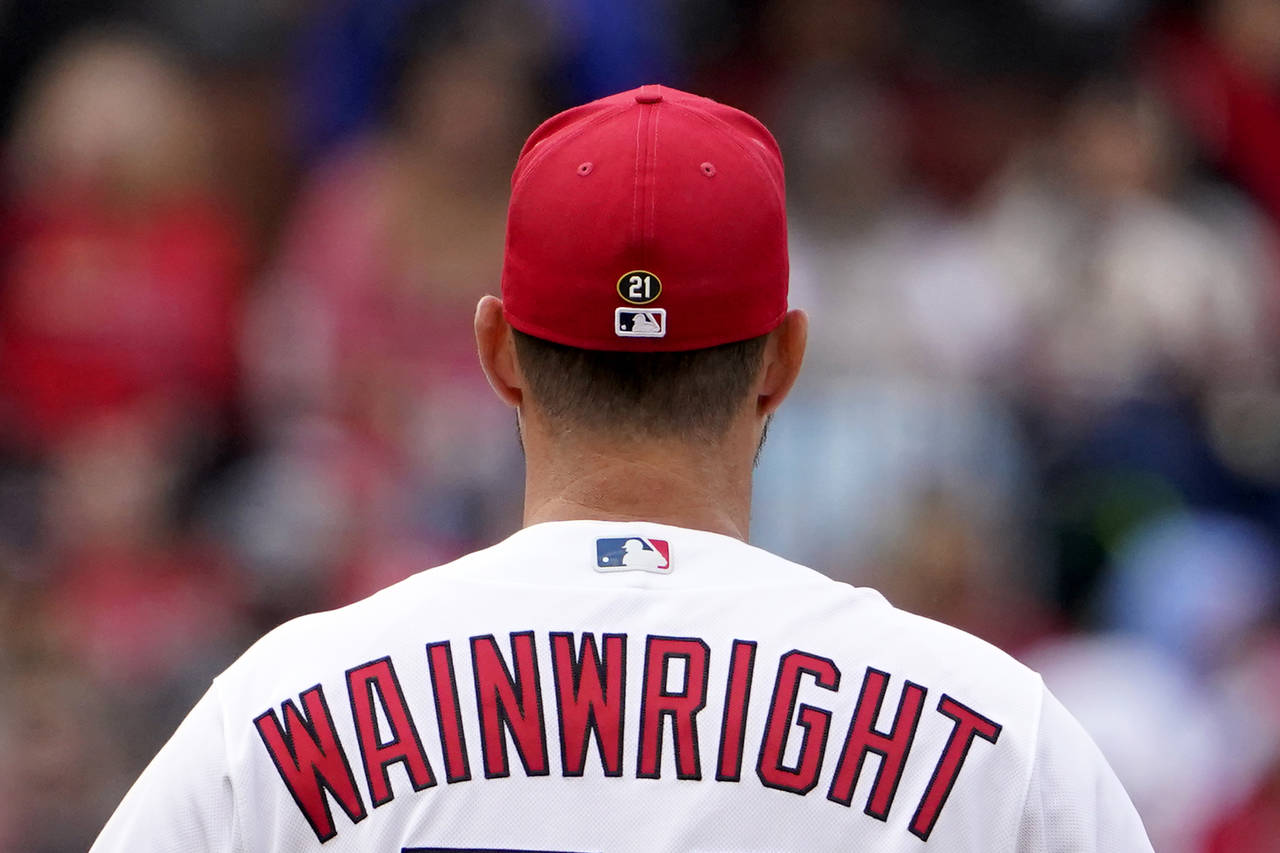 St. Louis Cardinals starting pitcher Adam Wainwright pauses between batters while wearing No. 21 on...