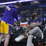 
              Los Angeles Lakers guard Austin Reaves, left, talks with LeBron James during the first half of the team's NBA basketball game against the Golden State Warriors in San Francisco, Thursday, April 7, 2022. (AP Photo/Jeff Chiu)
            