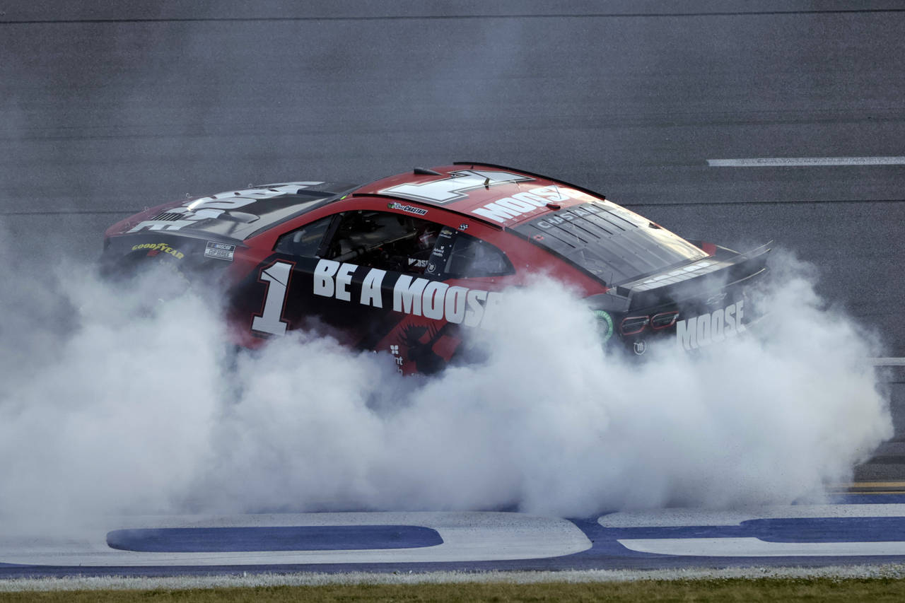 Ross Chastain celebrates with a burnout after winning a NASCAR Cup Series auto race Sunday, April 2...